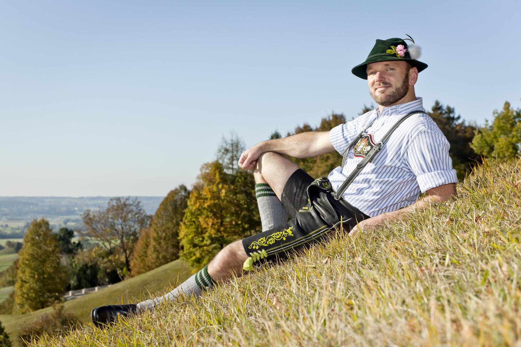 Man dressed in traditional costume (Tracht) on a mountain slope